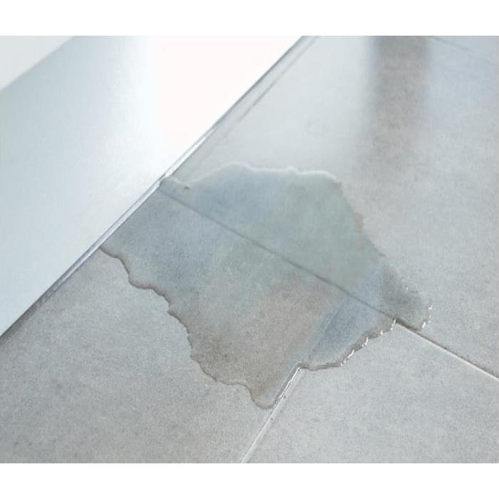 white tile floor with small puddle of water 