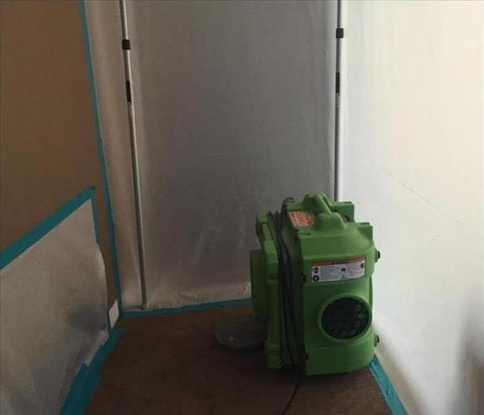 green air scrubber in small room, white walls 