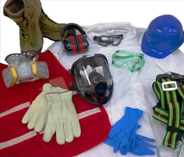 white background with work boots, gloves, goggles, helmet, and rubber gloves 